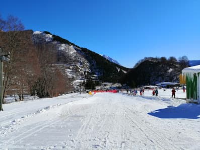 Winter sports center seen amongst snow-blanketed landscape in Pescasseroli, Abruzzo, Italy. The vivid winter sports scene and charming chalet add to the stunning winter scenery.