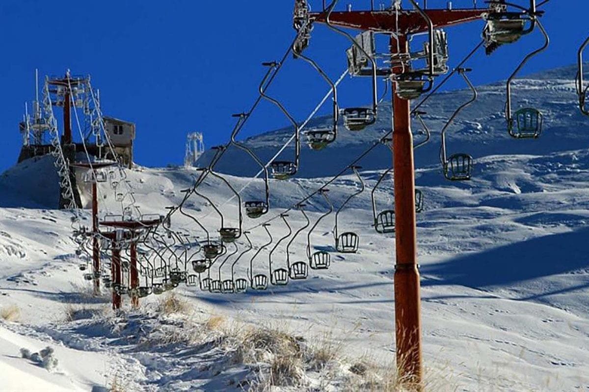 Brezovica in Kosovo - a ski lift going up a snowy mountain.