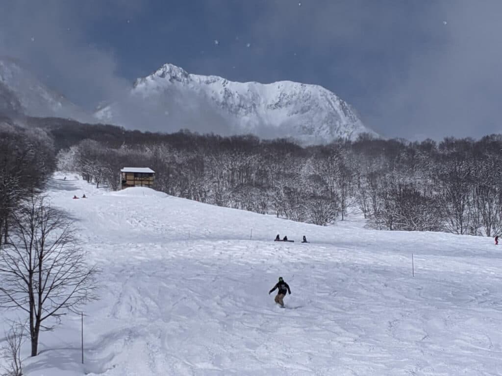 Ikenotaira Onsen in Japan - a group of people skiing down a mountain.