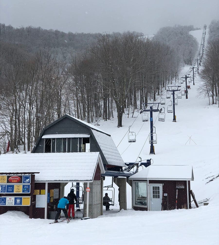 Song Mountain in USA - a ski lift going up a snowy hill.