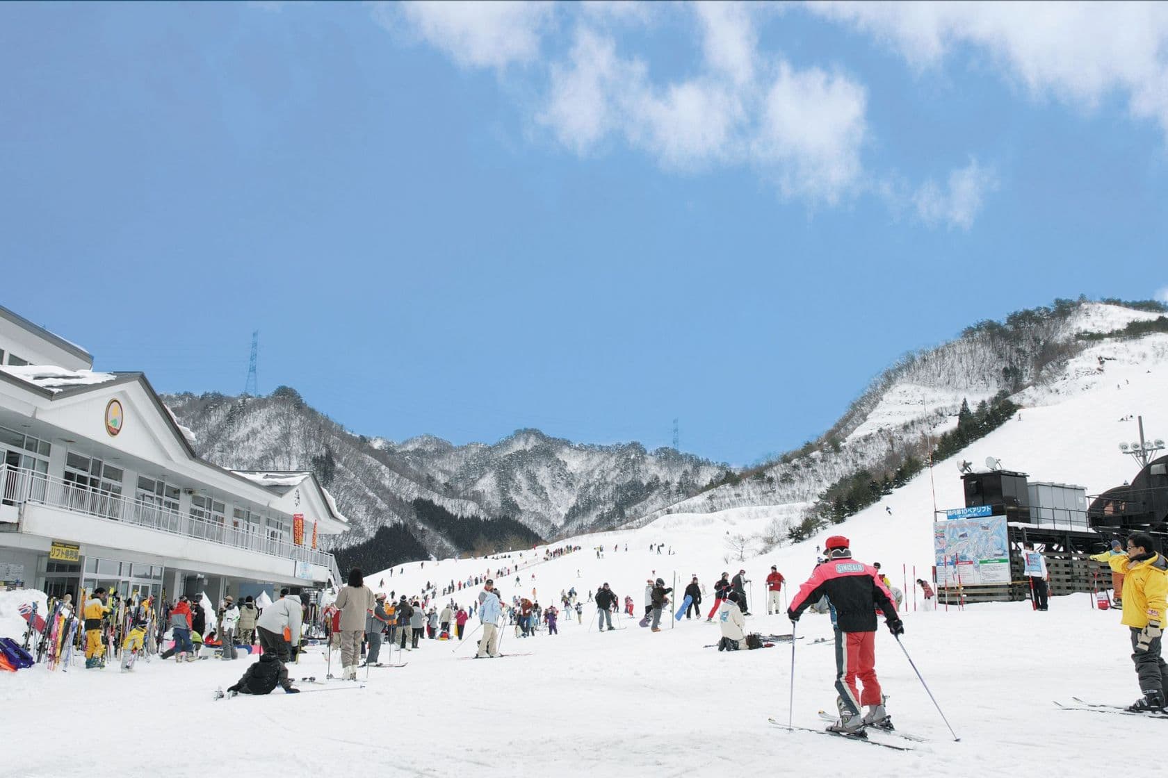 Tainai in Japan - a group of people skiing down a snowy slope.