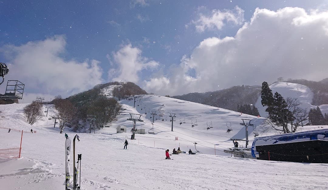 Winter scene at the Okuibuki ski resort in Kozuhara, Honshu, Japan; featuring snow-covered slopes perfect for winter sports, and a cozy chalet.