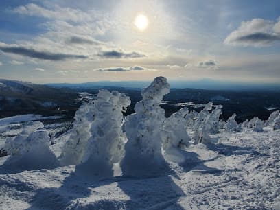 Stunning winter view at Hakkoda in Kansuizawa, Japan, featuring a lively winter sports scene on the snowy mountain slopes amidst breathtaking winter scenery.