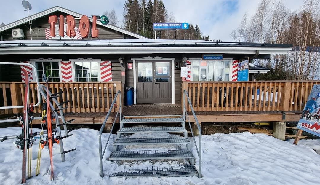 A snowy scene at Tahko ski resort in Kuopio, East Finland, featuring a ski lift leading to a lodge and winter sports. Scenic winter sports activities in progress in Northern Savonia's serene landscape.