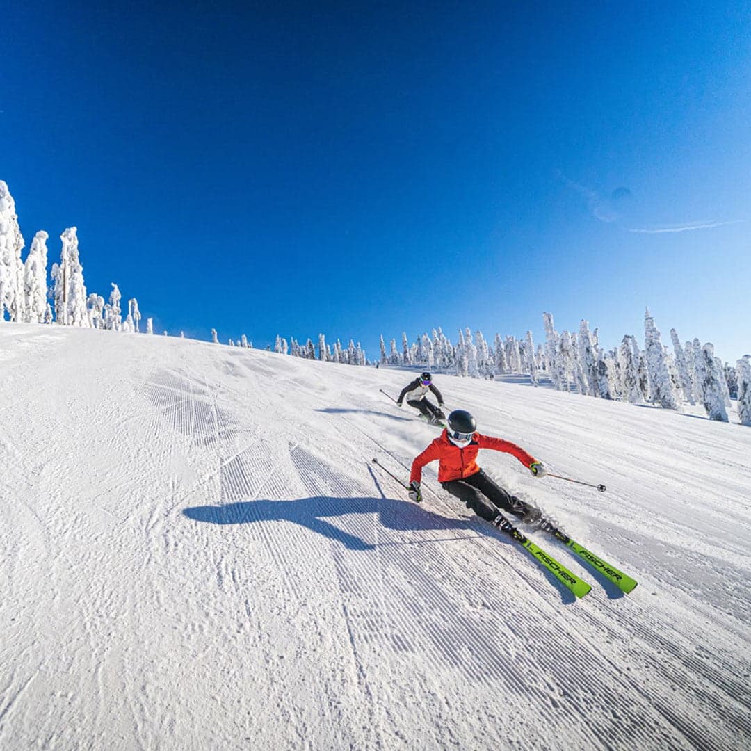 Tahko in Finland - a person is skiing down a snowy hill.