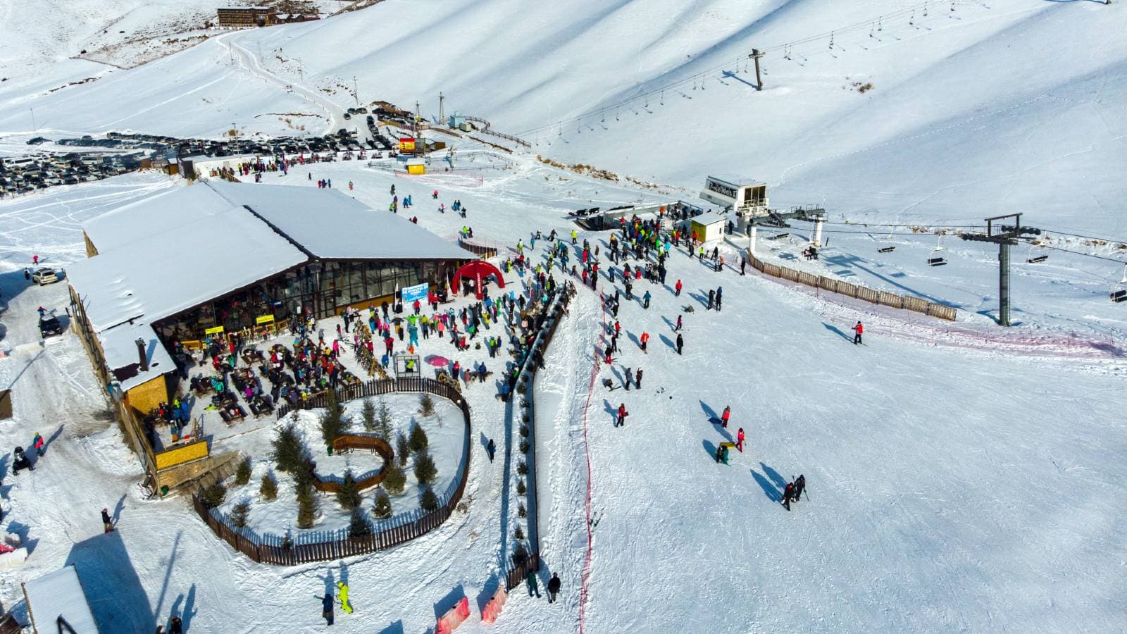 Chunkurchak in Kyrgyzstan - a group of people skiing down a snowy slope.