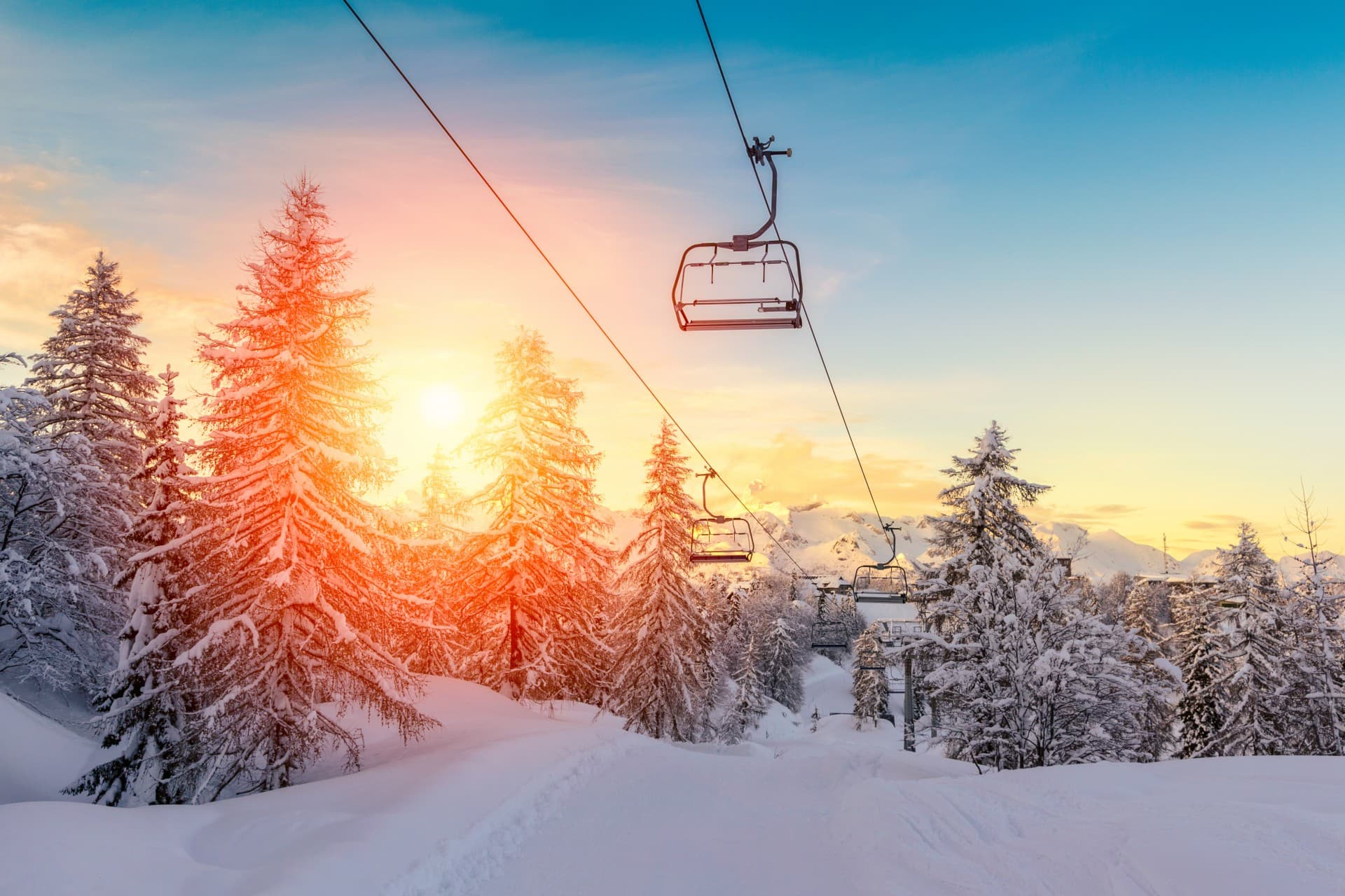 Winter scene at Cloudcroft in New Mexico, USA featuring a bustling ski resort with ski lifts, and skiers enjoying the snowy slopes amidst the picturesque winter scenery.