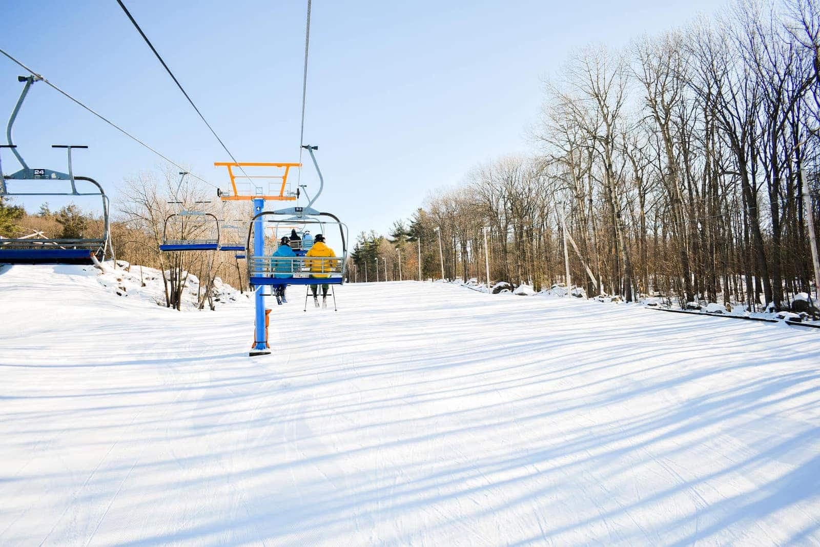 Mont Rigaud in Canada - a ski lift going up a snowy hill.