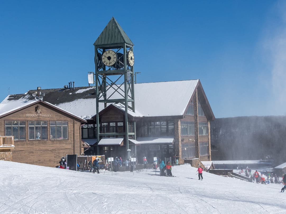 Hidden Valley - PA in USA: a group of people standing in the snow near a building.