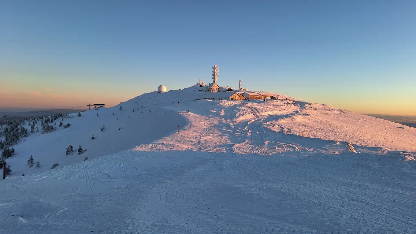 Kopaonik in Serbia - the summit of a mountain covered in snow.