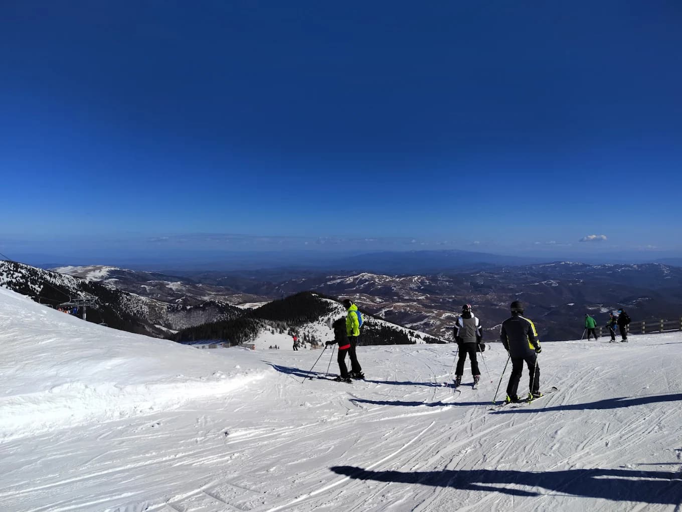 Kopaonik in Serbia - a group of people skiing down a mountain.