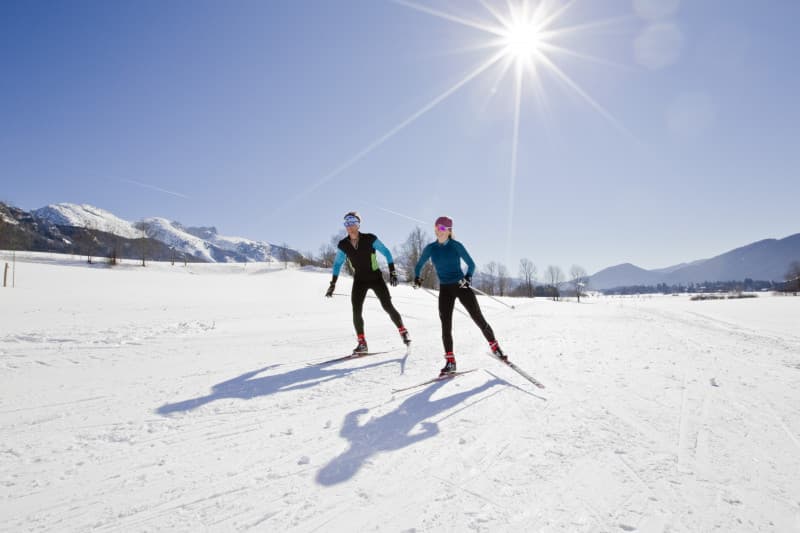 Winter sports scene at Lans en Vercors in France, featuring skiers of all ages enjoying the snow-filled slopes against the picturesque winter landscape.