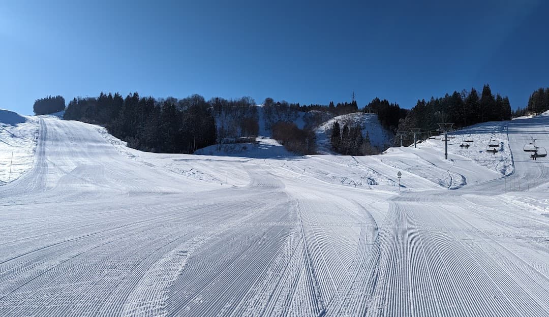 Snowy scene at Greenpia Tsunan showcasing a winter sports center ski resort and chalet amidst a picturesque winter landscape in Japan.