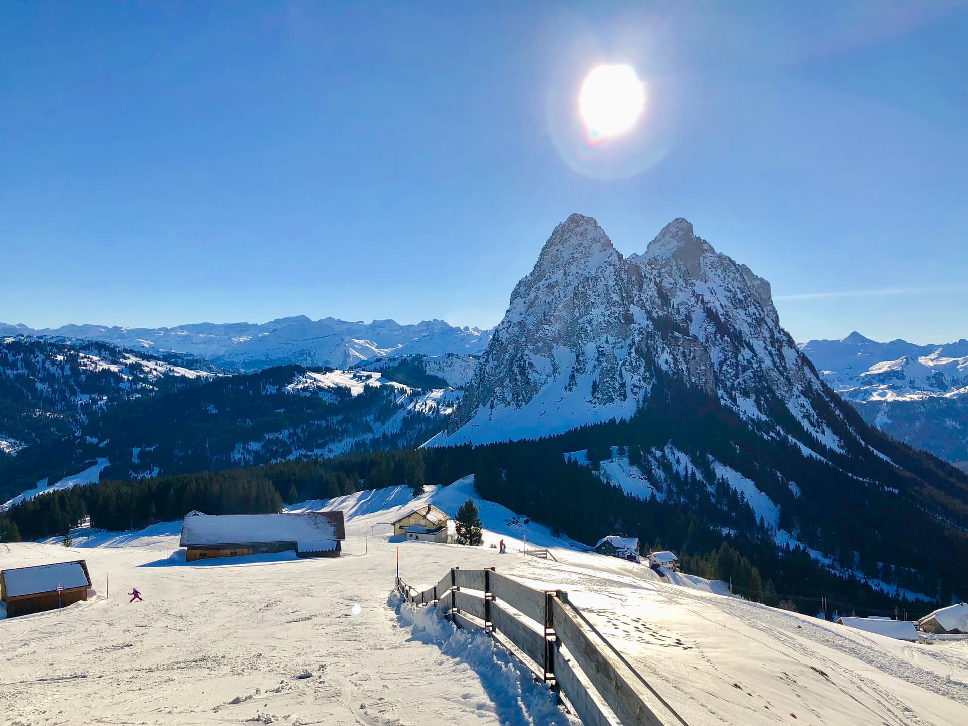 Winter sports scene at Brunni-Bahnen, Engelberg-Titlis, showcasing a vibrant winter sports centre against the backdrop of a majestic mountain, wrapped in stunning winter scenery.