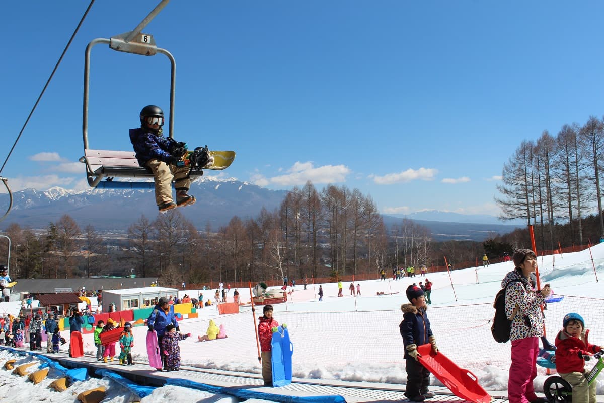 Fujimi Panorama in Japan - a person on a ski lift in the air.