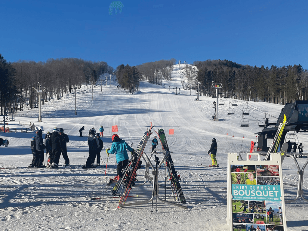 Bousquet in USA - a group of people standing on top of a ski slope.