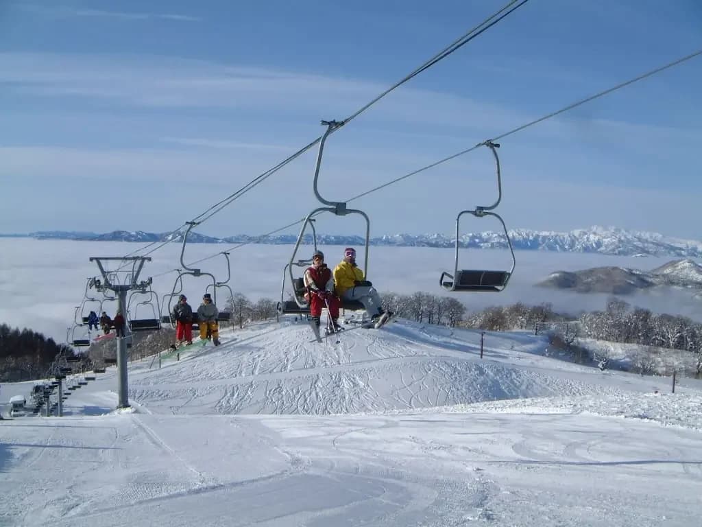 Hida Kawai in Japan - a group of people riding a ski lift.