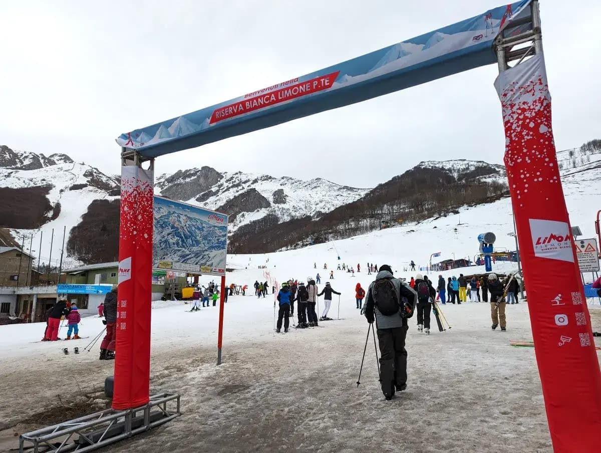 Lurisia Monte Pigna in Italy - a group of people skiing down a snow covered slope.