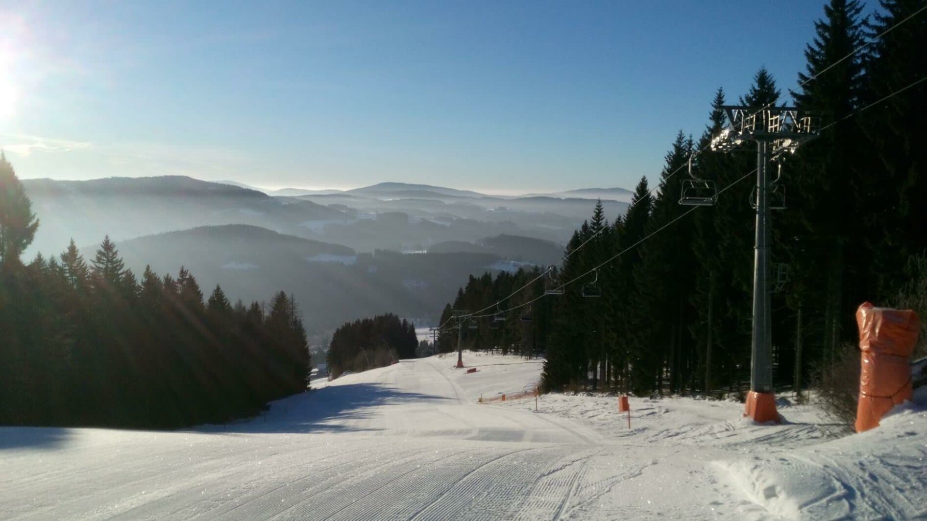 Ski-Waldheimat Hauereck in Austria - a ski slope with trees and snow on it.