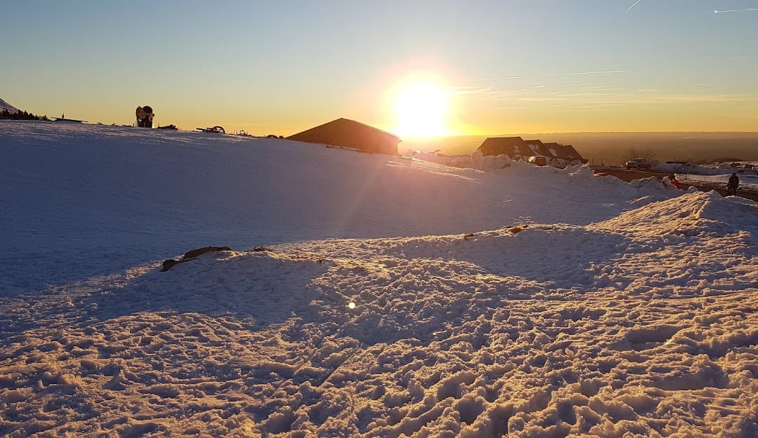 View of the snow-covered Chastreix-Sancy mountain in France, creating a stunning winter scenery complete with a glimpse of winter sports activity.