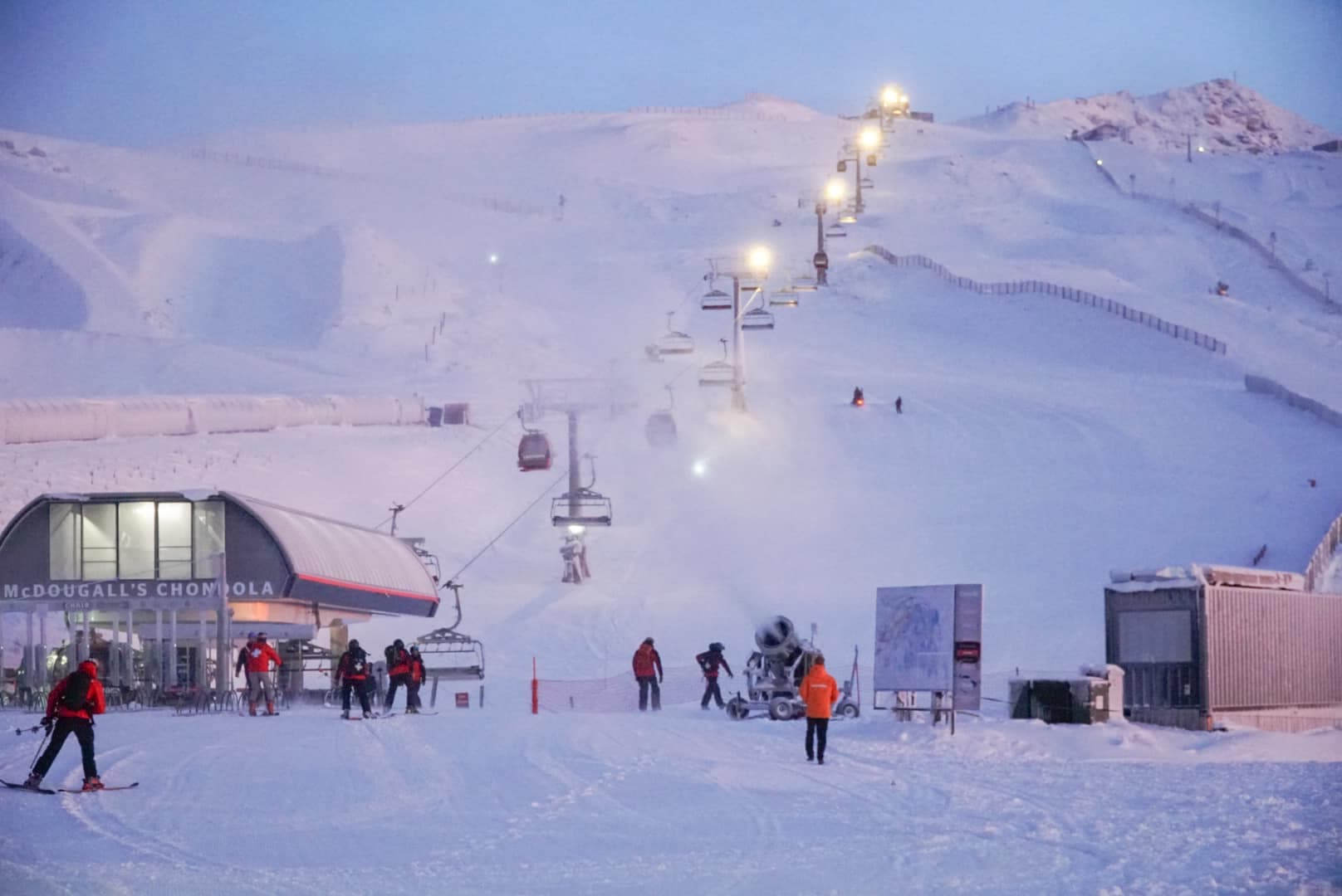 Porters in New Zealand - a group of people skiing down a snow covered mountain.