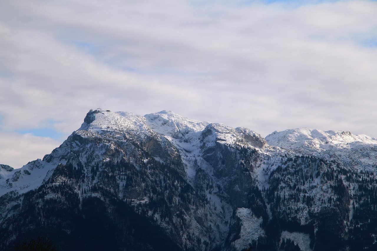 Unterberg in Austria - a large mountain covered in snow under a blue sky.