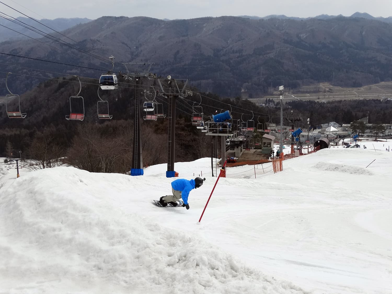 Okutone Snow Park in Japan - a person on a snowboard in the snow.