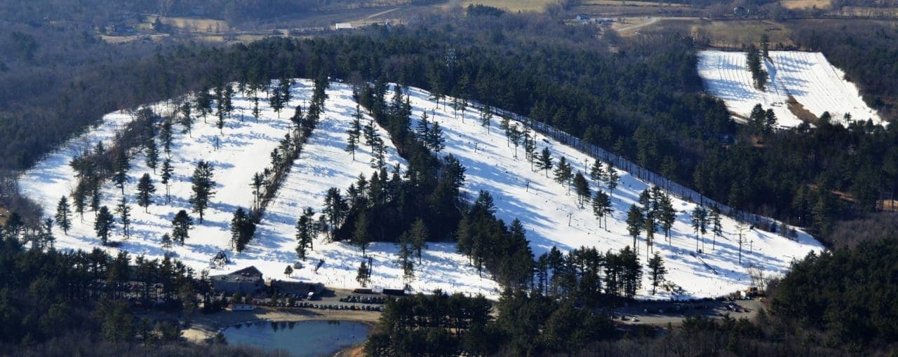 View of Nashoba Valley Ski Area in Westford, Massachusetts featuring a bustling winter sport scene with snow-covered slopes and a stunning winter landscape.