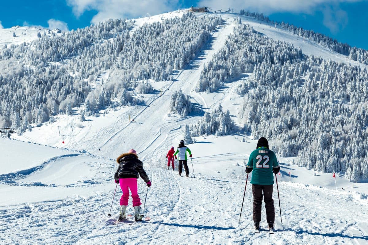 Bolkar Kayak Merkezi in Turkey - a group of people skiing down a snowy slope.