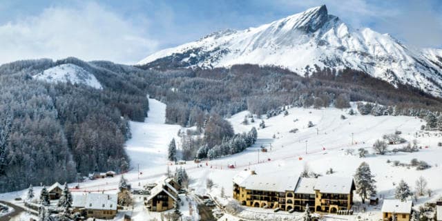 Ski resort in Laye, Hautes-Alpes, with a charming chalet situated amidst stunning winter scenery. A winter sports scene adds to the vibrant allure of this serene destination.