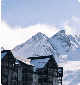 A ski resort nestled in the majestic mountains of Peyragudes Hautes-Pyrénées France bustling with winter sports enthusiasts. A charming chalet adds to the scenic beauty of the snow-clad landscape.