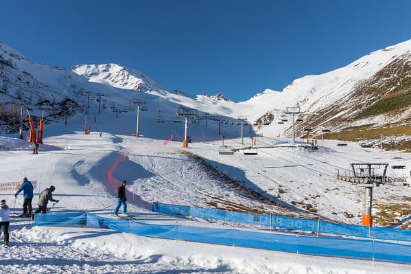 Peyragudes in France - a group of people riding ski boards down a slope.