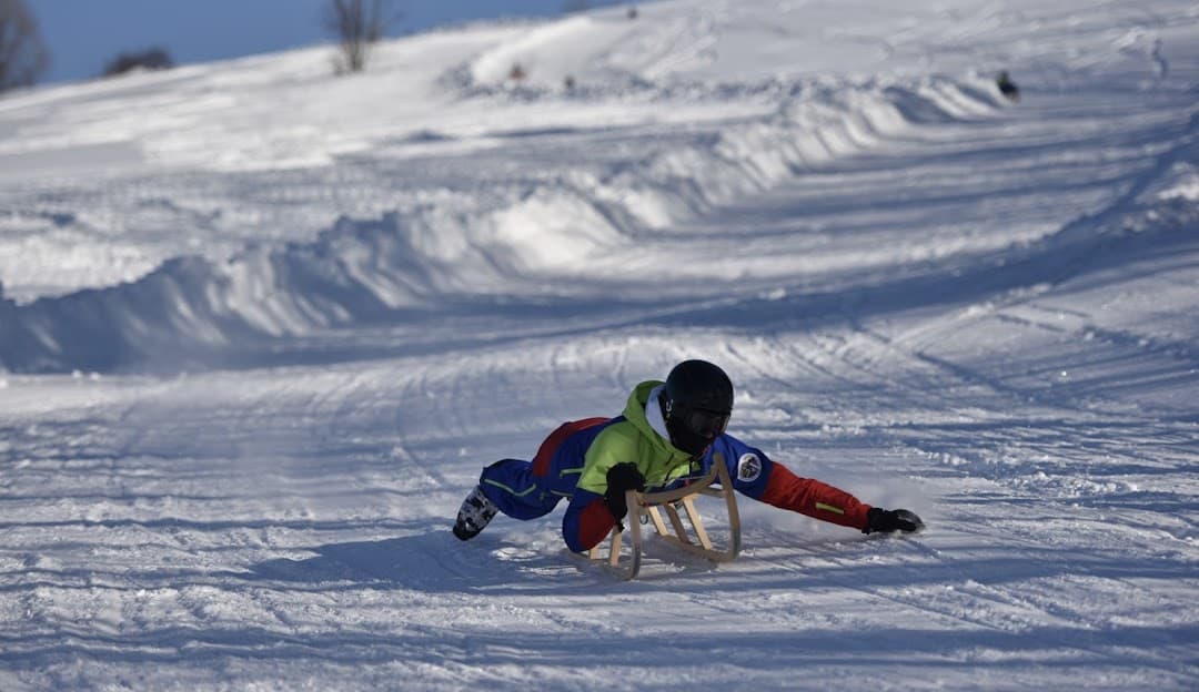 Stacja Narciarska GrapaSki in Poland - a person on a snowboard in the snow.