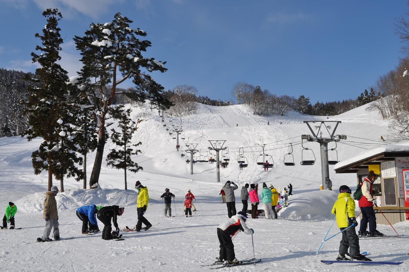 Asahi Shizen in Japan - a group of people skiing down a snowy slope.