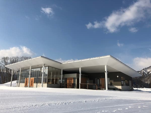 Asahi Shizen in Japan: a large white building sitting on top of snow covered ground.