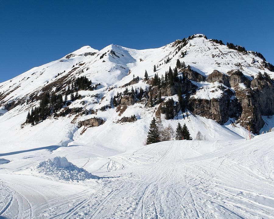 Gitschenen in Switzerland - a snow covered mountain with tracks in the snow.