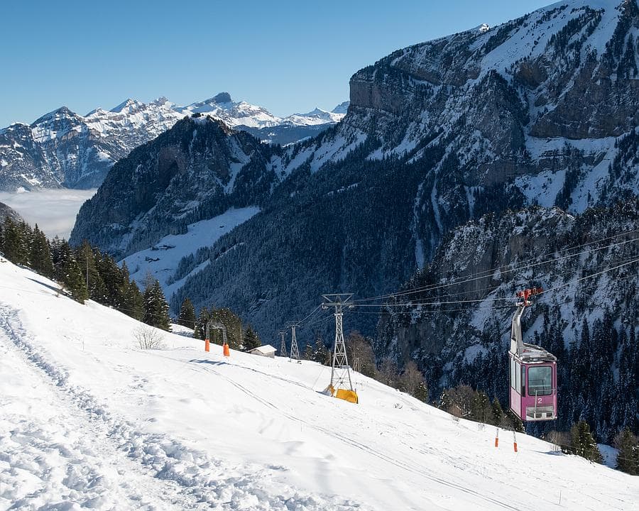 Gitschenen in Switzerland - a ski slope with a ski lift going down it.