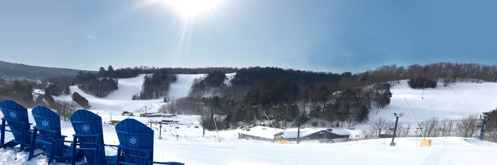 Hidden Valley Highlands in Canada - a blue chair sitting on top of a snow covered slope.