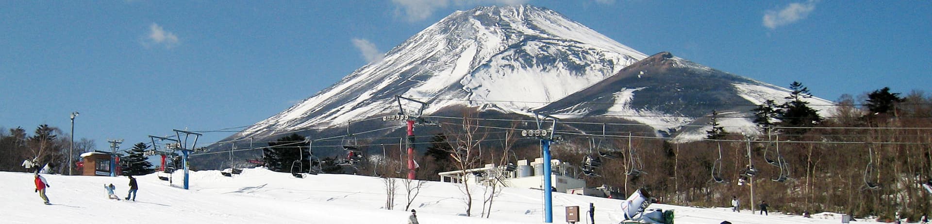 Yeti Resort in Japan - a group of people skiing down a mountain.