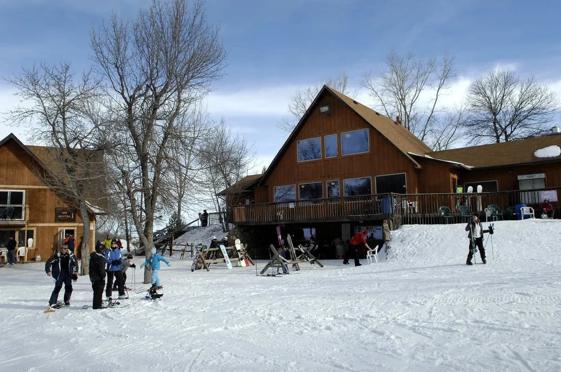 Huff Hills in USA - a group of people standing on top of a snow covered slope.