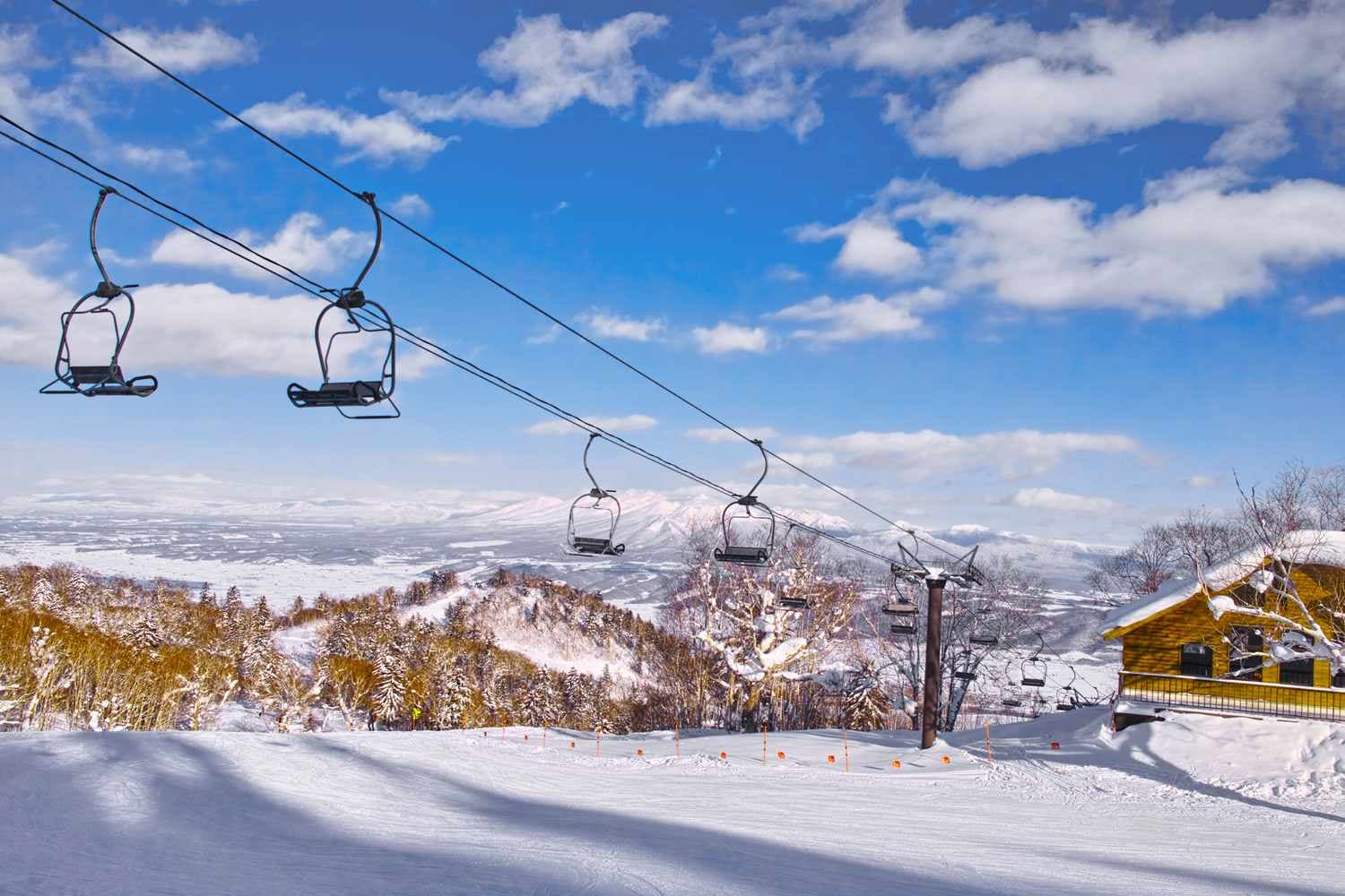 Furano in Japan - a ski lift going up a snowy slope.