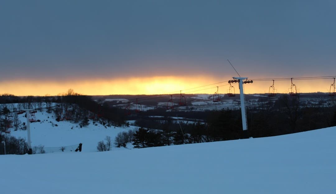 Sundown Mountain Resort in USA - the sun is setting behind the ski lift.