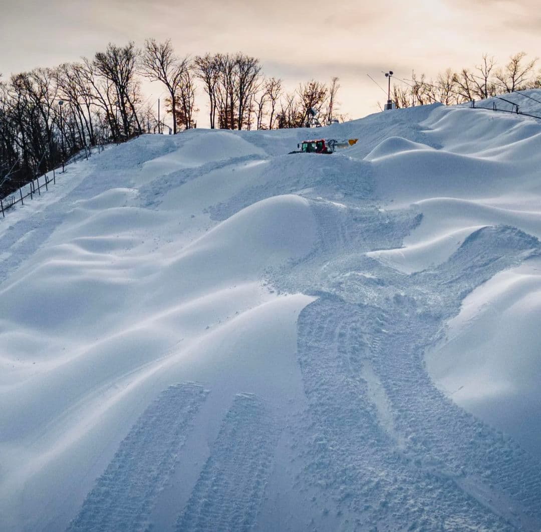 Wild Mountain in USA - a person riding a snowboard down a snow covered hill.