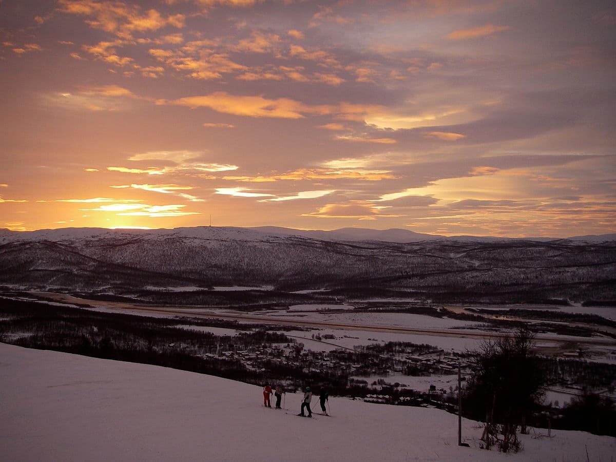 Hemavan in Sweden - a group of people standing on a snow covered hill.