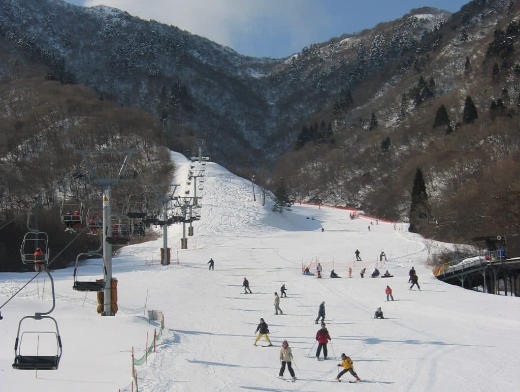 Kutsuki in Japan - a group of people skiing down a mountain.