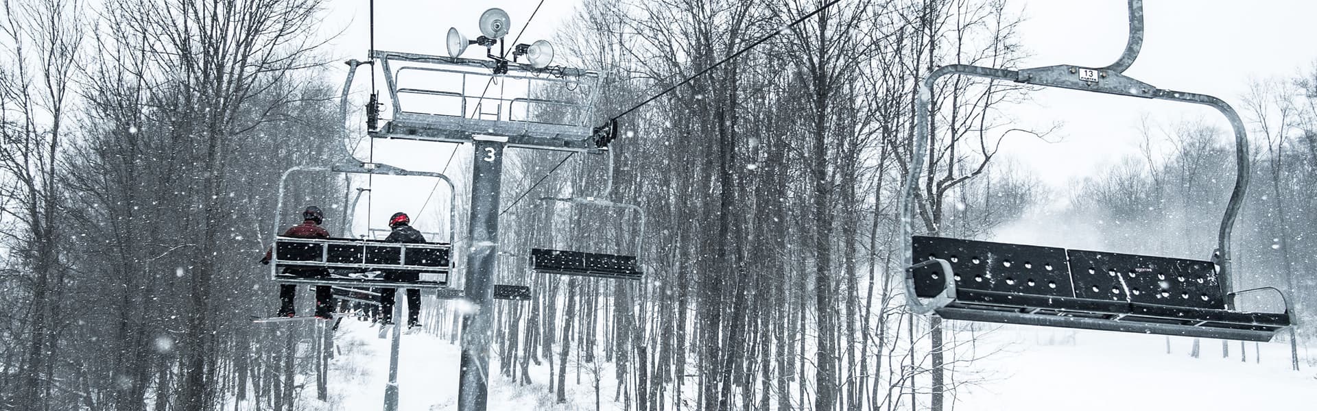 Alpine Valley Ohio in USA - a person riding a ski lift in the snow.