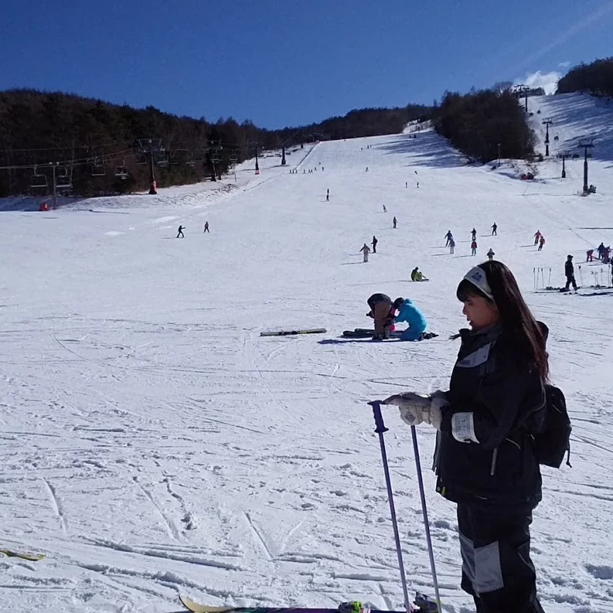 Shirakaba Kogen in Japan - a group of people skiing down a snowy hill.