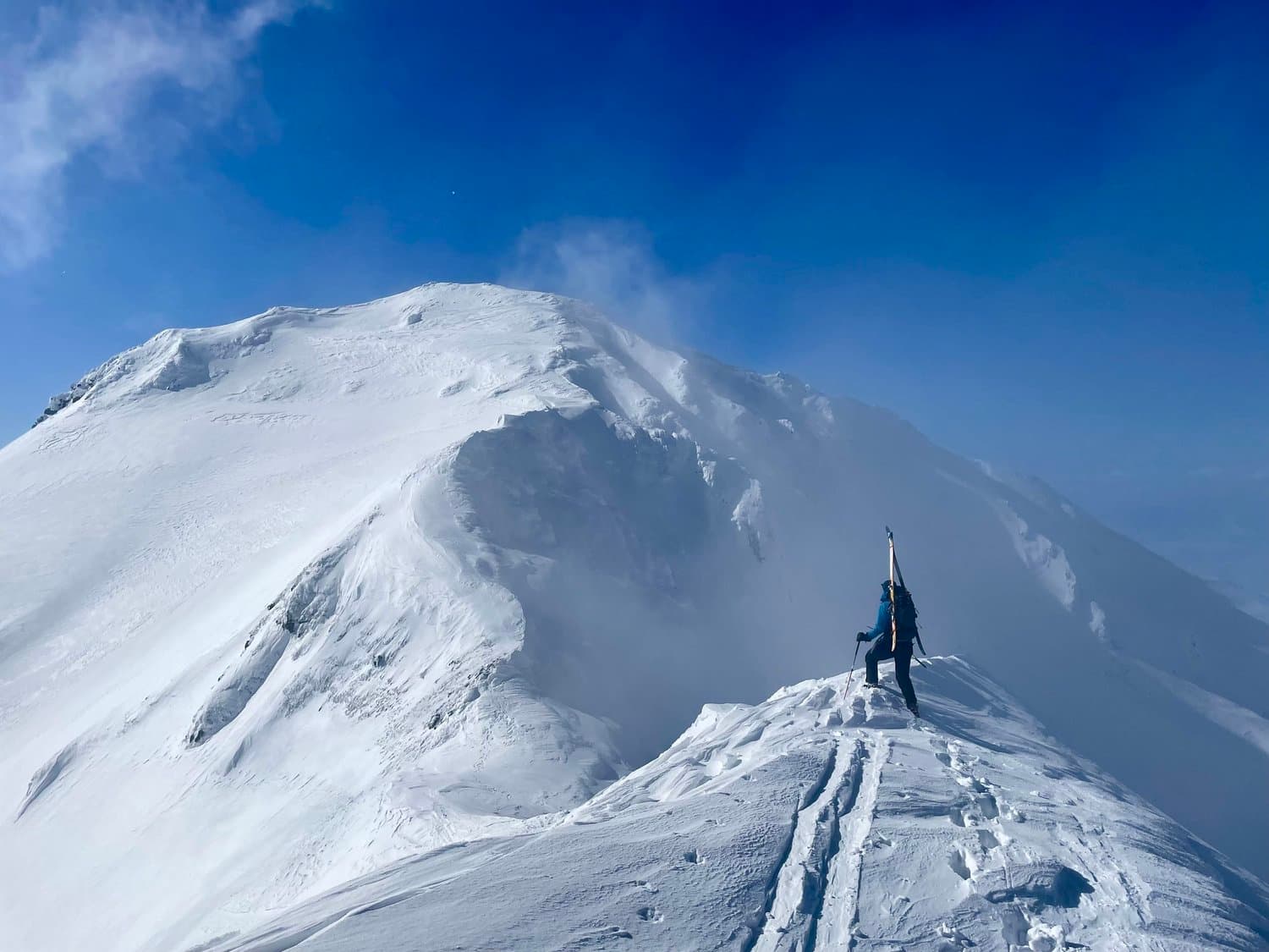 Asahi in Japan - a person standing on top of a snow covered mountain.