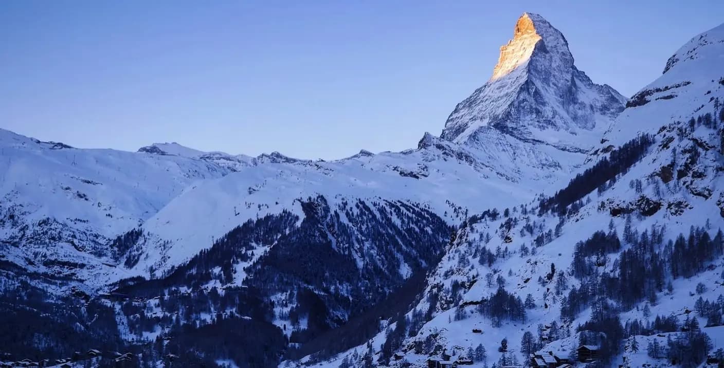 Springenboden in Switzerland - a mountain covered in snow at sunset.