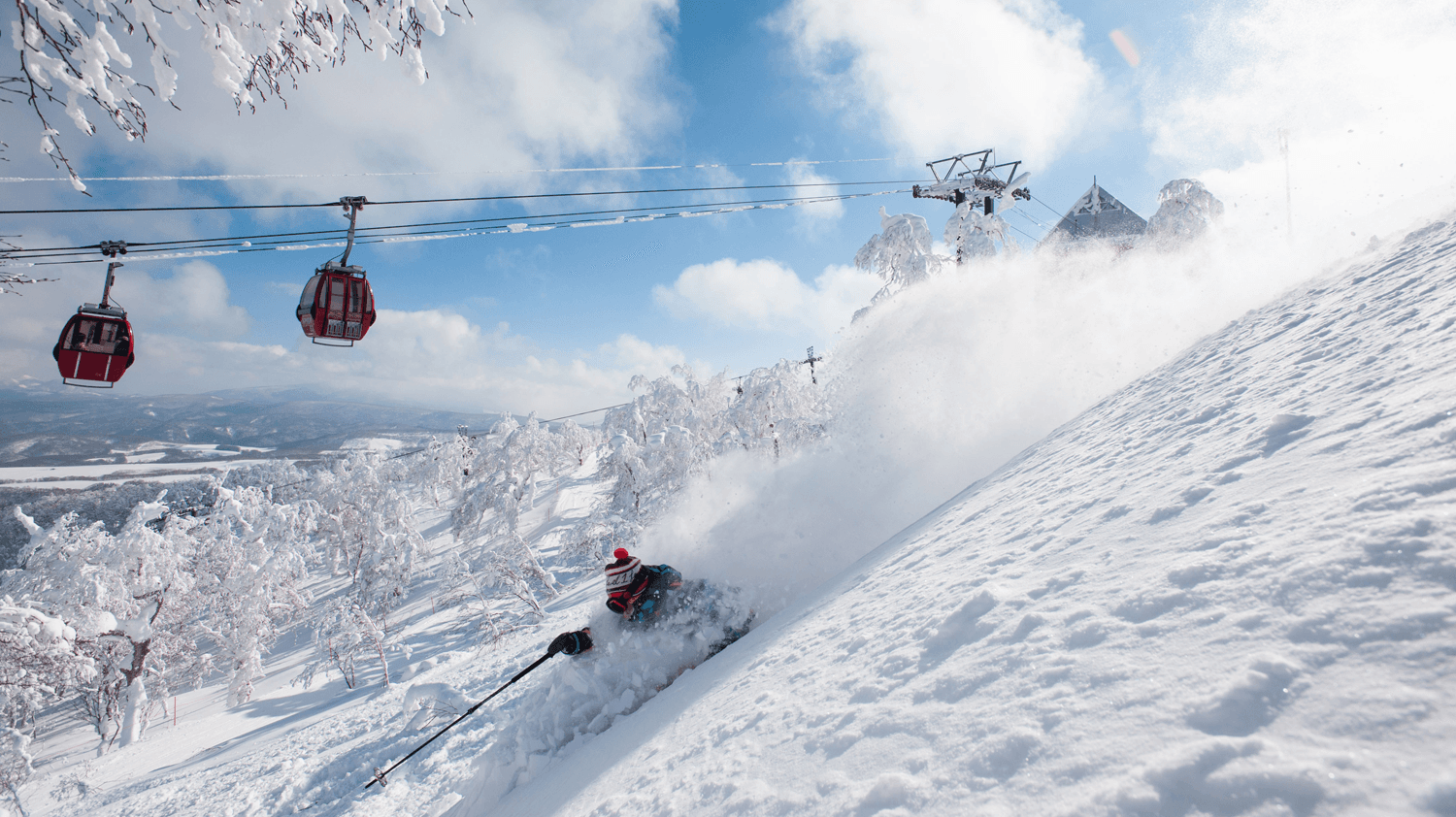 Alshan Alpine in China - a person is skiing down a snowy hill.